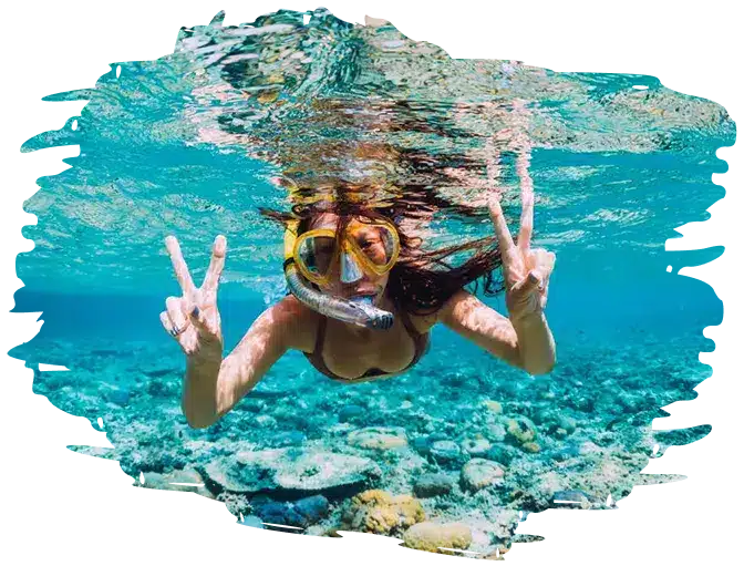 young girl underwater snorleing in shallow crystal clear water doing peace to the camera