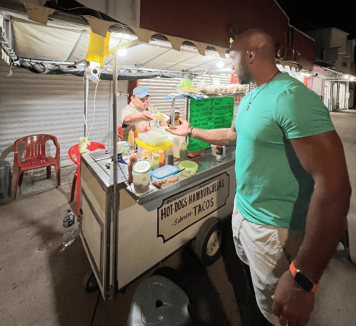 A person grabbing a taco from coozumel street food vendor