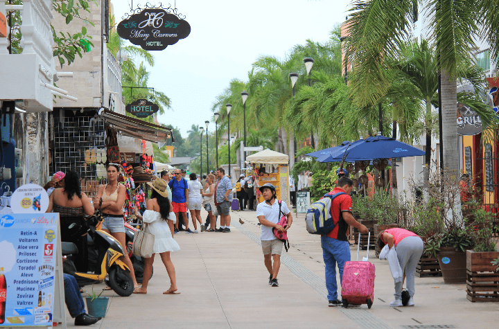 Tourists in downtown Cozumel walking for frew
