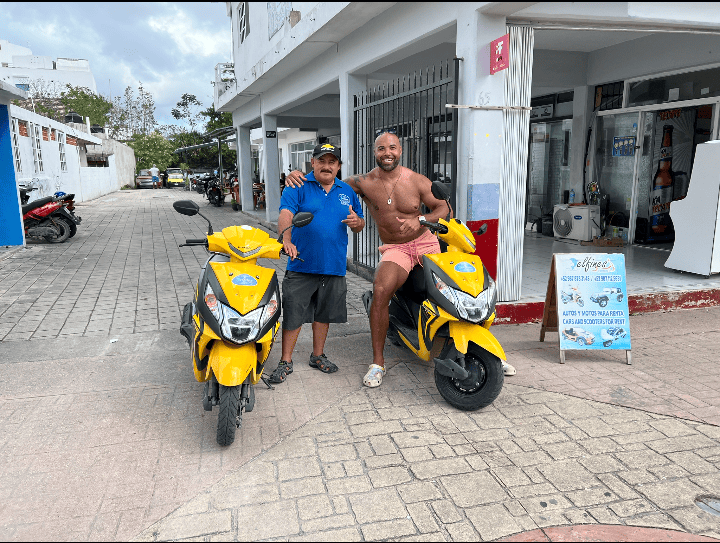 Me and the scooter rental onwer sitting on scooters