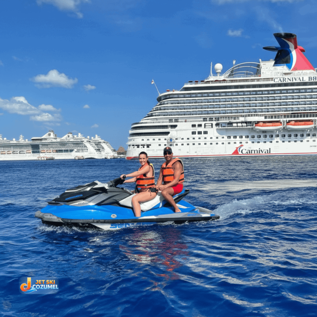 A older couple enjoying a Cozumel jet ski tour. Posing smiling with two cruise ships in the background. The water is a deep blue