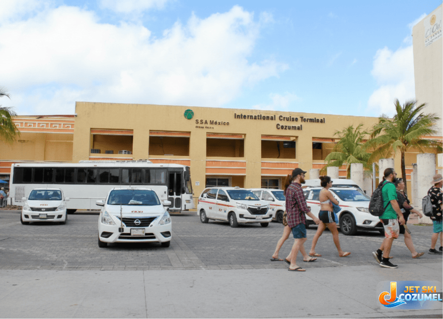 Cozumel mexico taxes rates from in front of international Pier with 6 taxis parked waiting for travelers