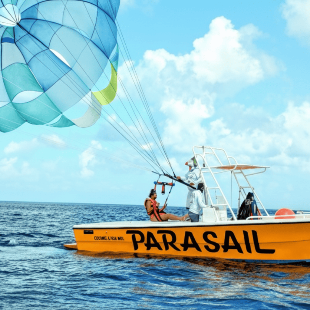 A side view of Parasailing Cozumel showing a woman sitting in the boat deck harnessed in and the parachute fully deployed about to take off