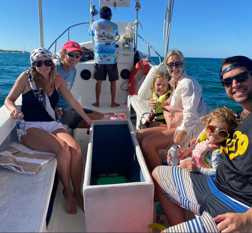 Cozumel-private-snorkeling-tours – Jet Ski Cozumel A photo of a family of 6 with two small children on a Cozumel private snorkeling tour boat traveling with a captain standing driving.