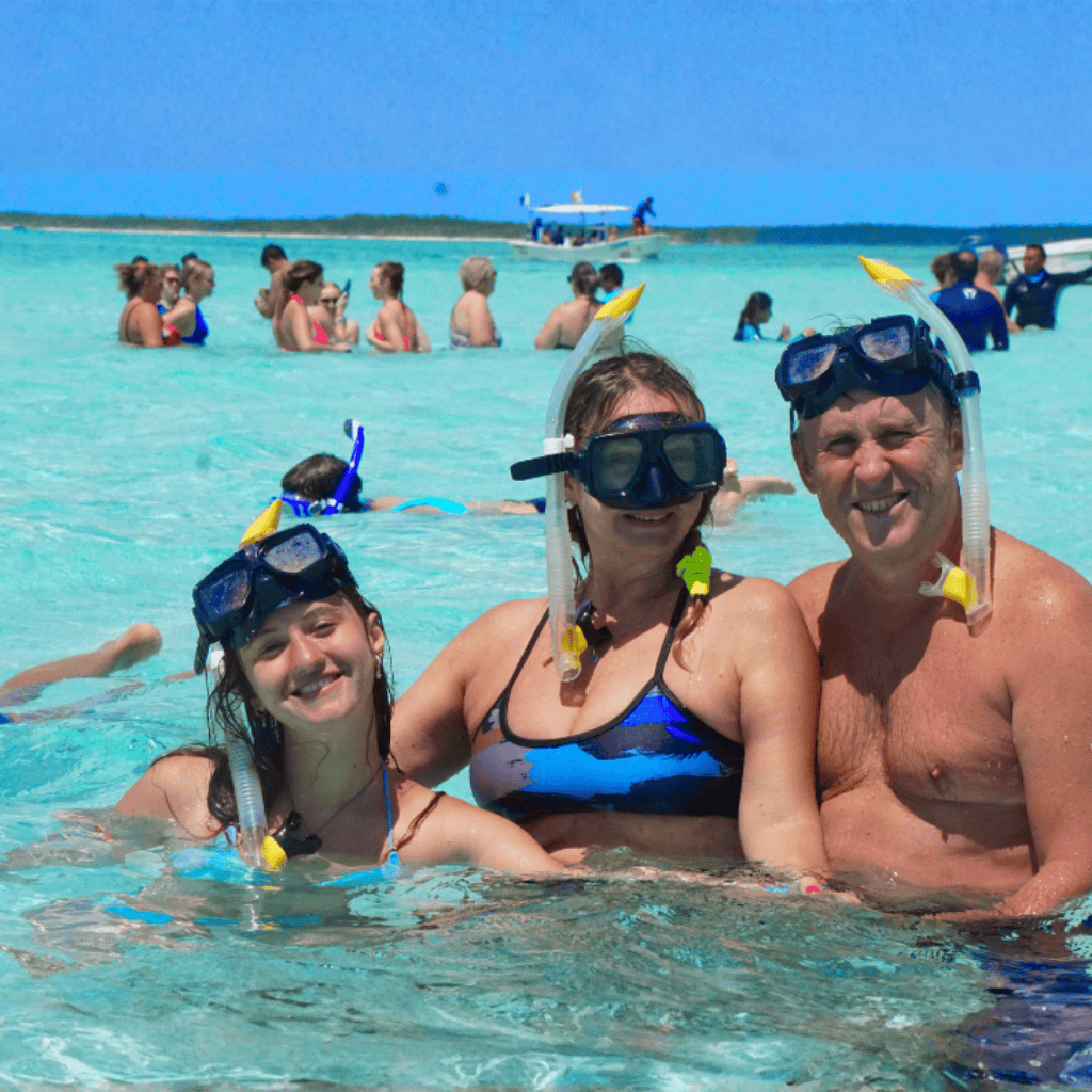 Snorkel tour boat at El Cielo Beach, Cozumel showing two adults and a young girl smiling with people in the background