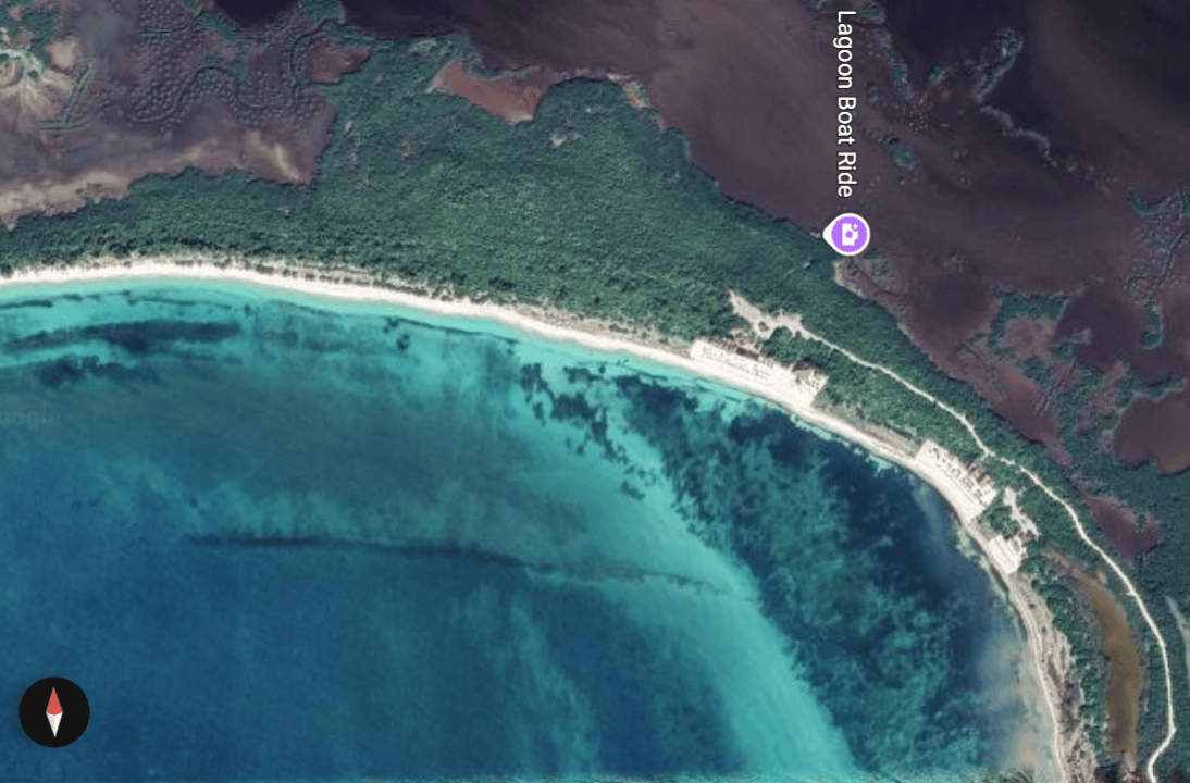 snorkeling-punta-sur-reef-cozumel – Jet Ski Cozumel Aerial view of a crescent white-sand beach, turquoise lagoon, and dense green forest along the coast with a Lagoon Boat Ride marker on the map.